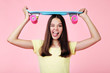 © 5second - Young girl with skateboard on pink background