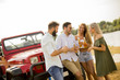 © BGStock72 - Young people drinking and having fun by car