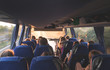 Tourist tour on the bus. People travel by bus. Salon of the great tourist bus with people at sunset