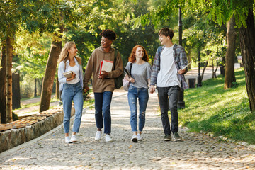 Wall Mural - Group of happy student walking at the campus outdoors