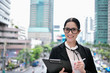 © S photographer - Business concept. Young businesswoman is working in business district. Young businesswoman happy to work.