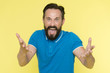 © be free - What are you doing. Stop annoying him. Overwhelmed with emotions. Handsome shouting mature man screaming standing against yellow background. Man bearded irritated annoyed can not keep calm anymore
