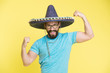 © be free - Man cheerful face in sombrero hat posing with biceps muscles strong gesture yellow background. Mexican party concept. Guy looks festive in sombrero. Party and holiday. Mexican traditional attribute