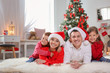 © New Africa - Happy parents celebrating Christmas with children at home