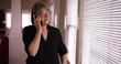 © Mark Adams - Happy senior lady having chat with family on cell phone inside her home