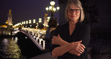 Lovely Mature Woman With Stern Look Crossing Arms By Pont Alexandre III In Paris