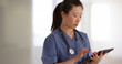 © rocketclips - Professional young doctor or nurse using portable tablet inside hospital