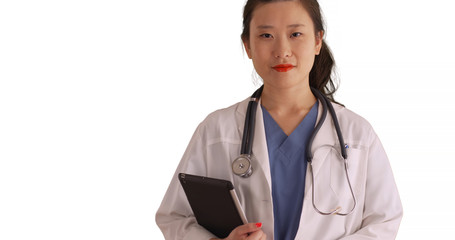 Professional female doctor carrying tablet pc looking at camera for copyspace