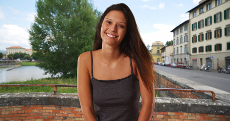 Wall Mural - Beautiful Caucasian girl wearing tank top standing on street in Venice Italy