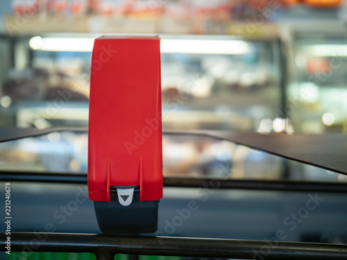 Fotografie, Obraz Ticket dispenser sitting in front of line at a local deli counter with copy spac