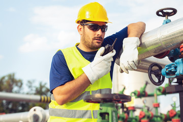 Wall Mural - Worker in the oil field talking on the radio