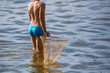 © schankz - A boy is catching a fish net in the pond