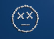 © fStop - Pills forming dizzy face on blue background