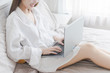 © fufupix - female hands type on keyboard of laptop computer in bedroom, successful business woman, working at home, looking for information