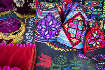 Wall Mural - Market stalls with decorative tribal textile with colourful pattern made in Central Asia, Uzbekistan.