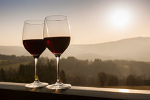 Two Wine Glasses At Sunset Time.