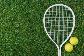 top view of tennis equipment of green grass