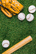 Flat Lay With Baseball Equipment Arranged On Green Grass