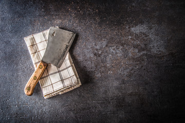 Wall Mural - Old meat butcher on dark concrete board