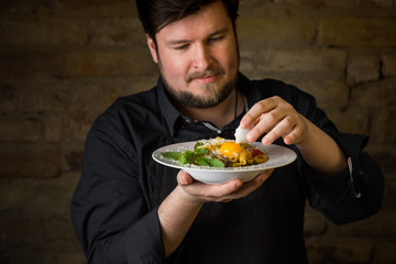 Wall Mural - Chef serving Italian pasta with cheese, vegetables and egg yolk. Dark background copy text.