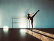 © Nikita Vasylchenko - A young girl is doing stretching in the dance hall.