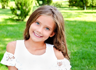 portrait of adorable smiling little girl child outdoors