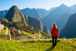 Woman looking at Machu Picchu at sunrise