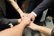 © Thammasiri - Business team work concept. Business people joining hands
