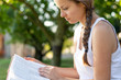 © PhotoGranary - Christian worship and praise. A young woman is reading the bible in the early morning with sun in the background.