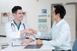 © pixs4u - Young doctor shaking the hand of middle-aged patient male