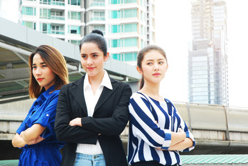 Beautiful business women team portrait and offices building background.