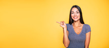Photo Of Young Excited Beautiful Happy Brunette Woman, Girl Pointing Away And Smile Isolated On Yellow Background Banner