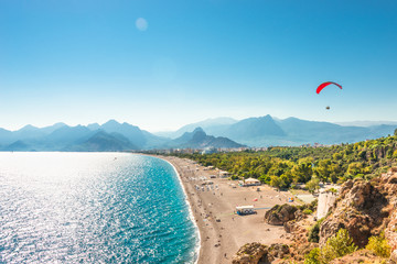 panoramic bird view of antalya and mediterranean seacoast and beach with a paraglider, antalya, turk