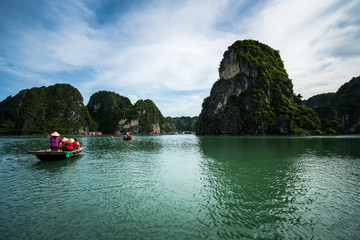 Halong bay in Vietnam, UNESCO World Heritage Site, with tourist rowing boats