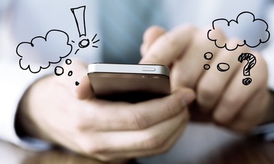 Businessman in suit holding phone in hands on background