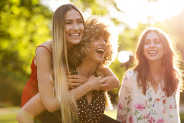 Wall Mural - female friends on sunny summer evening