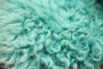 Close up of a green dyed sheepskin rug as a background