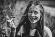 © Alexander - happy young woman smiling and holding a marijuana leaf outdoors