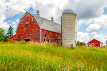 An Old Barn And Silo Stand Tall On A Hill In Minnesota