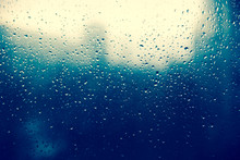 Raindrop On Glass Window, Blue Drops. City Silhouette