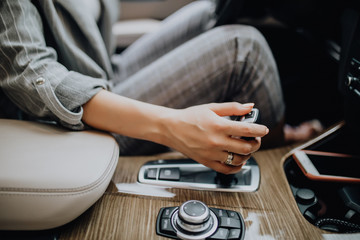 Business woman hand using a car automatic gear. Woman driving concept