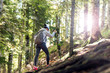 © Novak - Active female hiker walking and exploring forest