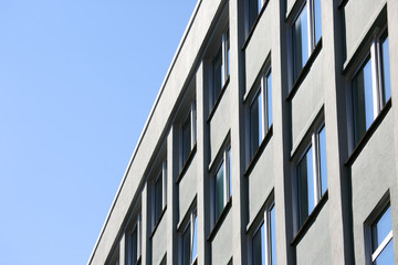 The facade of the building with Windows on the background of blue sky