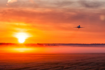 Picturesque dawn with a fog at the airport. Takeoff of a private jet