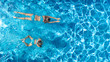 © Iuliia Sokolovska - Aerial drone view of children in swimming pool from above, happy kids swim on inflatable ring donuts, girls have fun in water on family vacation