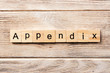 appendix word written on wood block. appendix text on table, concept