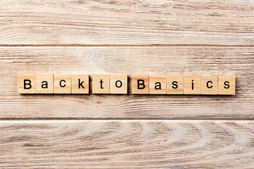 back to basics word written on wood block. back to basics text on table, concept