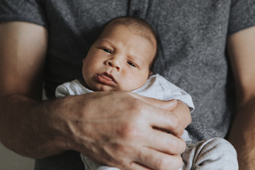 Wall Mural - young father holding his baby