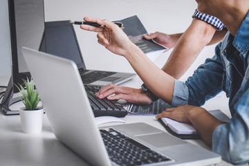 Writing codes and typing data code technology, Programmer cooperating working on web site project in a software developing on desktop computer at company