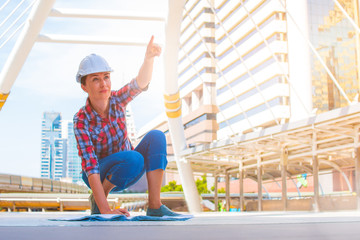 Industrial construction engineer wear safety helmet engineering working and drawings inspection on building outside. Engineering tools and construction concept. Business industry concept. copy space.